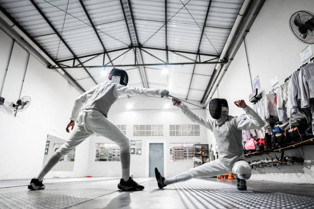 istock Men practicing fencing at a health club 2182854164