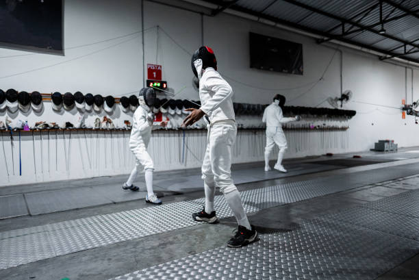 istock Men practicing fencing at a health club 2182854366