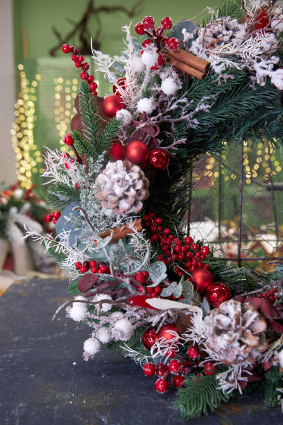 istock modern Christmas wreath with needles and dried flowers on a light background 2182855916