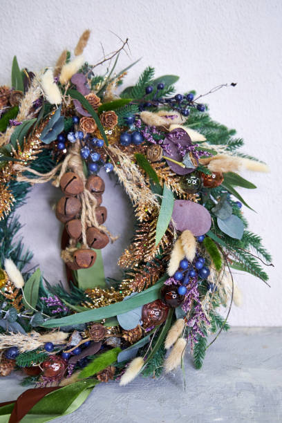 istock modern Christmas wreath with needles and dried flowers on a light background 2182856271