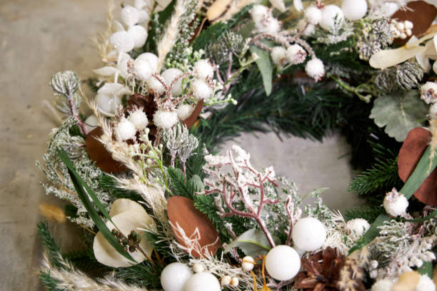 istock modern Christmas wreath with needles and dried flowers on a light background 2182856381