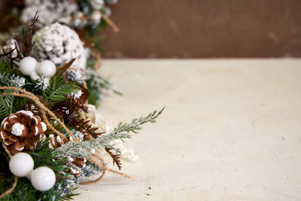 istock Christmas pine garland with cones on brown with beige background 2182857169