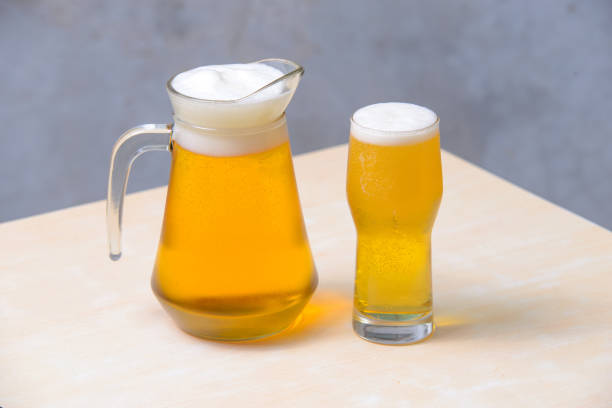 istock Beer in a glass draft beer pitcher on the wooden table. 2182858679
