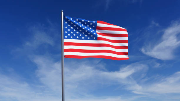 istock American flag waving in blue sky. 2182858836