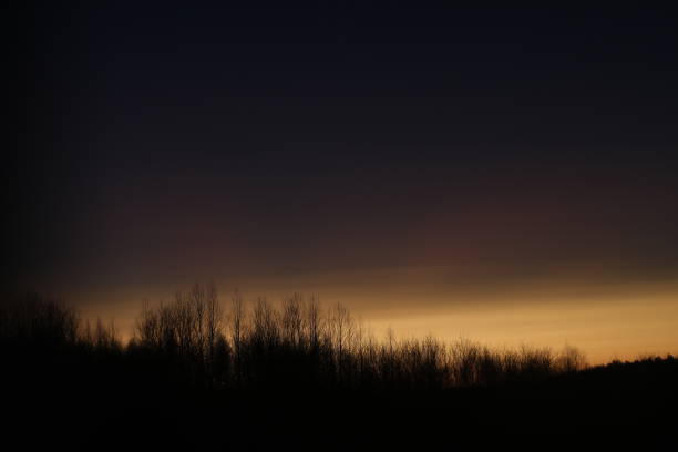 Sunset clouds mirrored in the window. Nature sunset sky backdrop. Blurry abstract sunrise background.