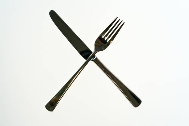 Mexican Table: Silverware on Vibrant Striped Tablecloth.  Shot in Oaxaca.