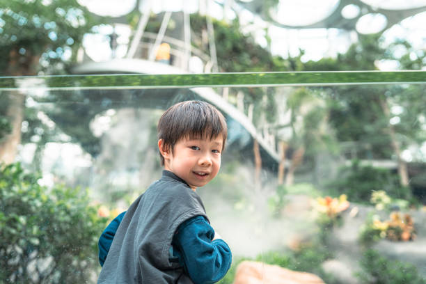 istock a little boy in the botanical garden 2182860890