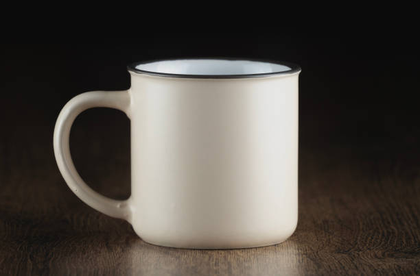 istock enamel mug with a black rim sits on a wooden tabletop 2182861595