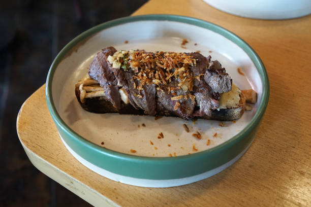 Close up plate of grilled beef and mushroom on toast