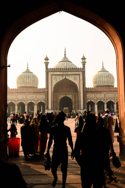 DELHI INDIA-November 27, 2021: Tourists and pilgrims pray in Jama Masjid mosque . Jama Masjid the largest mosque in New Delhi, India