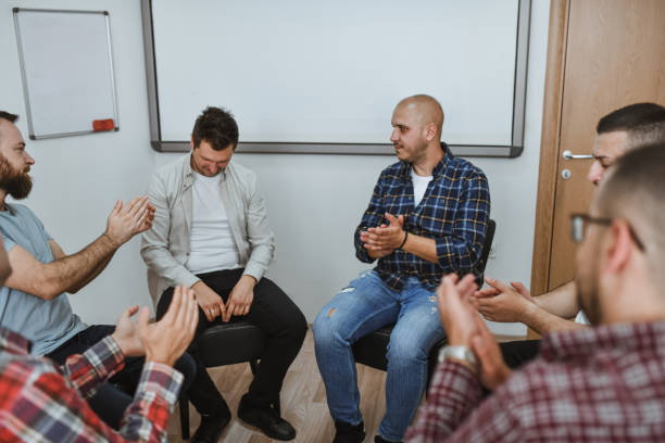 istock Emotional Male Getting Applause and Support from Group Therapy Members After Being Honest and Vulnerable 2182863498