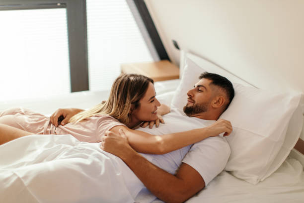 istock Couple lying in bed after waking up 2182864665