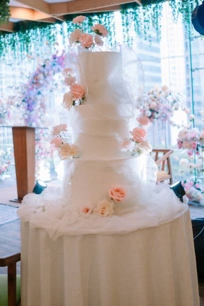 Beautiful naked wedding cake with flower decoration.