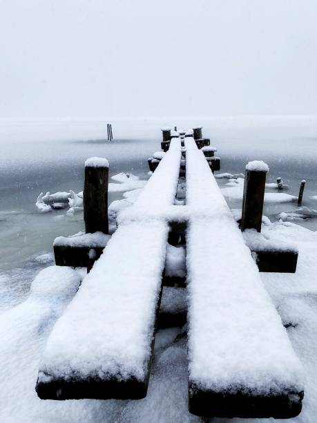 istock Snow on wooden pier 2182865615
