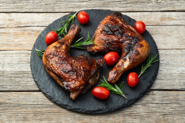 istock Grilled chicken legs with tomatoes and salad . Top view 2182866050