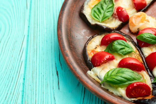 istock Italian mini pizza . Aubergine (eggplant ) with mozzarella cheese and basil . On rustic background 2182866497