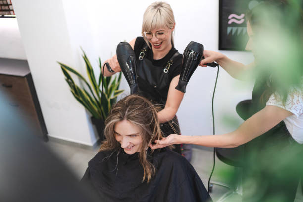 istock Two Professionals Blow-Drying Hair 2182867455
