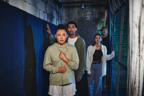 istock Adventurous young friends solving puzzles in an immersive quest room during a fun outing 2182867676
