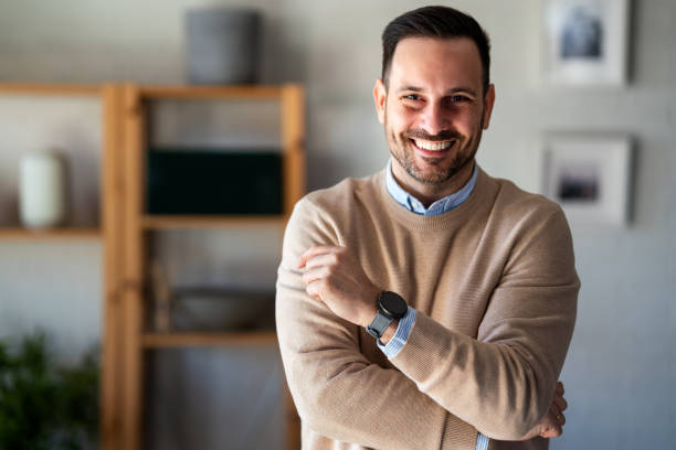 istock Satisfied with work done. Happy young man working on laptop while sitting at his working place 2182867685