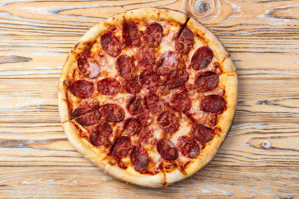 istock Pizza pepperoni fast food . Top view on rustic background 2182868368
