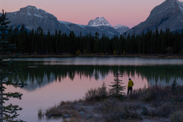 istock Man fishes on lakeshore in alpenglow 2182870164