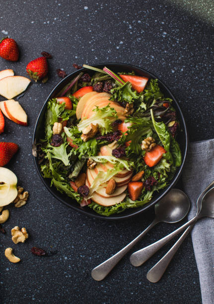 istock Tasty salad with apple, papaya, lettuce, top view.  Vegetable salad. 2182870310