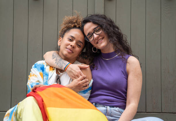 istock Multiethnic women couple hugging while sitting isolated no green background 2182874028