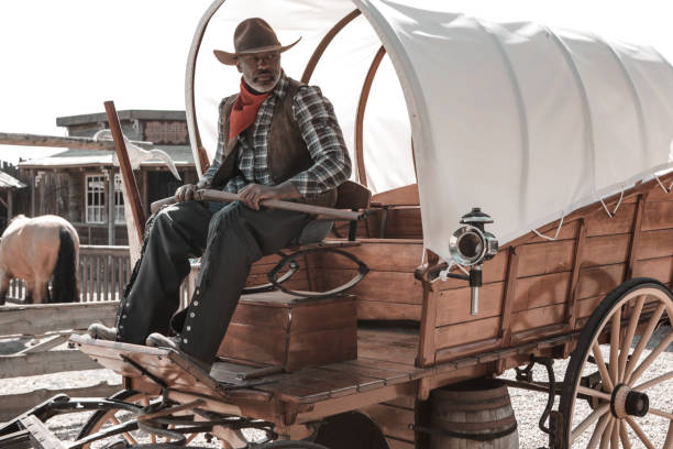 Handsome Black Cowboy in an authentic wild west setting Handsome Black Cowboy in an authentic wild west setting larping stock pictures, royalty-free photos & images