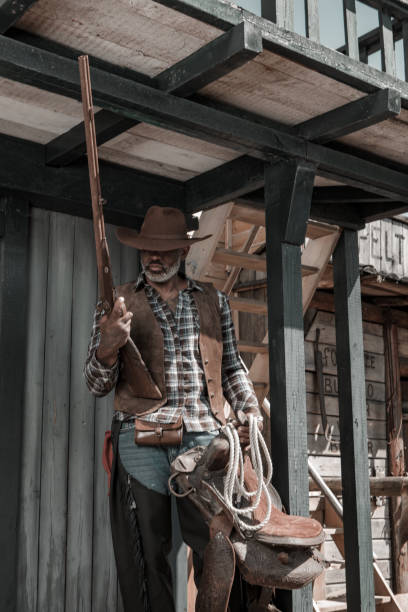istock Handsome Black Cowboy in an authentic wild west setting 2182875025
