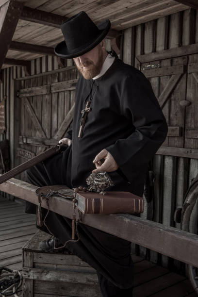 istock Handsome redhead Cowboy priest with an owl in an authentic wild west setting 2182875673