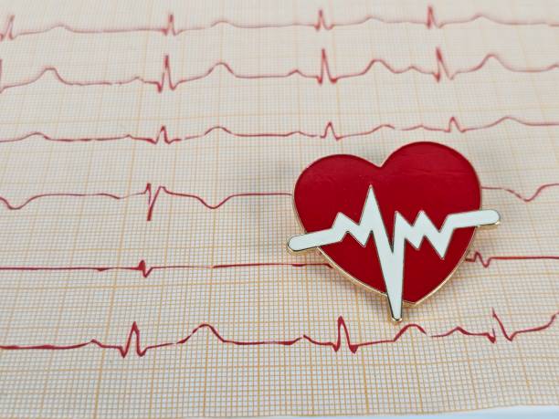 istock A red heart pin resting on an electrocardiogram chart showing heartbeat patterns 2182876682