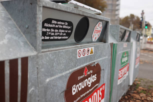 Glass recycling containers managed by Remondis are seen in Mannheim, Germany, organized by color for efficient waste sorting.