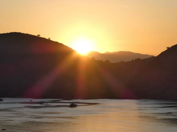 Sunset at komodo national park, see the sun appear from the mountains