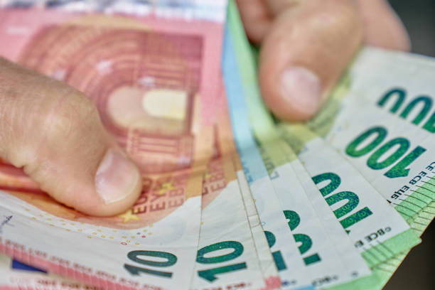 istock Hand Holding Euro Banknotes for Financial Transaction 2182879244