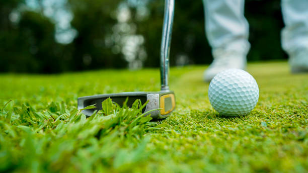 istock golfer playing golf in the evening golf course, on sun set evening time. 2182880633