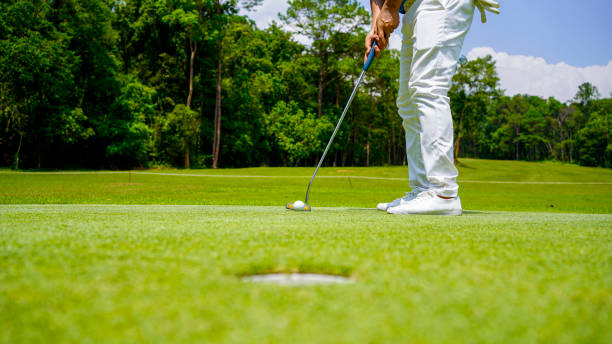 istock golfer playing golf in the evening golf course, on sun set evening time. 2182880656
