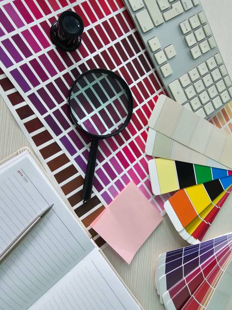 istock Workspace setup featuring color palettes, a magnifying glass, and office supplies 2182881787