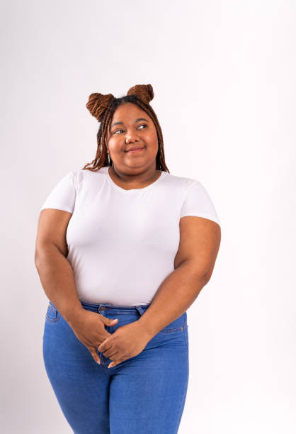 istock Overweight african young woman with shy expression 2182882064