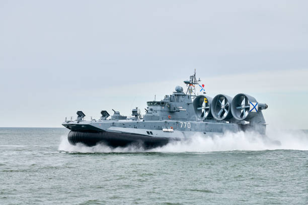 istock Hovercraft warship armed with armament sails into sea toward military target to attack and destroy 2182883008