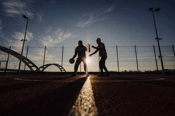 Father and son playing basketball outdoor
