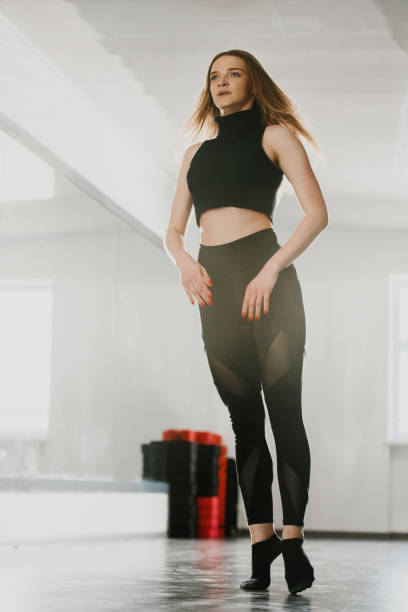 istock A young attractive woman is engaged in modern dance choreography in a ballet studio. 2182886372