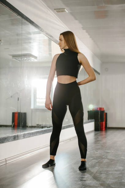 istock A young attractive woman is engaged in modern dance choreography in a ballet studio. 2182886448