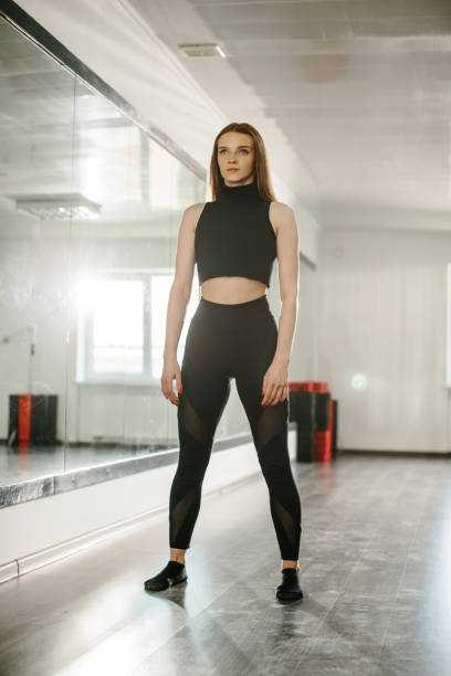 istock A young attractive woman is engaged in modern dance choreography in a ballet studio. 2182886467