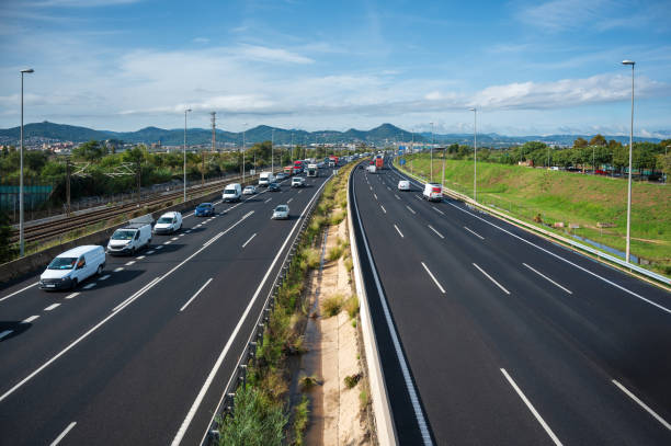 istock Highway traffic flowing on a sunny day with mountains in the background 2182886577