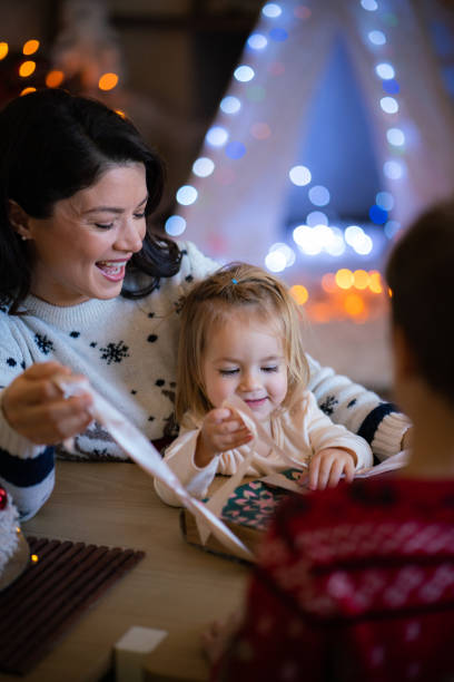 istock Happy family opens Christmas presents 2182893178