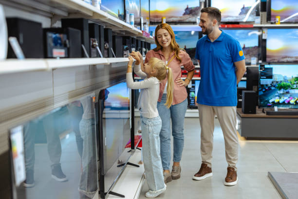 istock Family shopping for electronics at a store with friendly assistance 2182894081