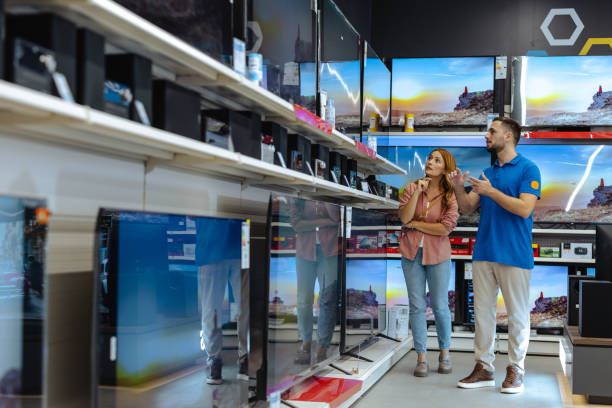 istock Woman receiving assistance from store employee in electronics section 2182894090