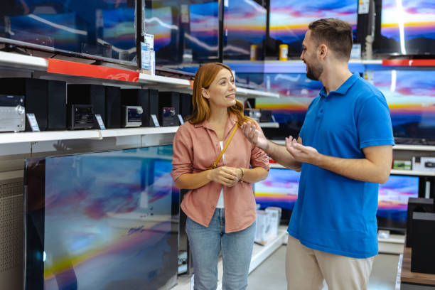 istock Woman receiving assistance from store employee in electronics section 2182894124