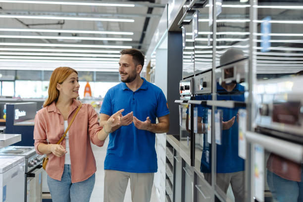 istock Female customer and employee discussing electronics in store setting 2182894273
