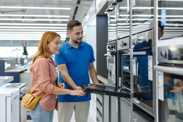 istock Female customer shopping for kitchen appliances in modern store 2182894313